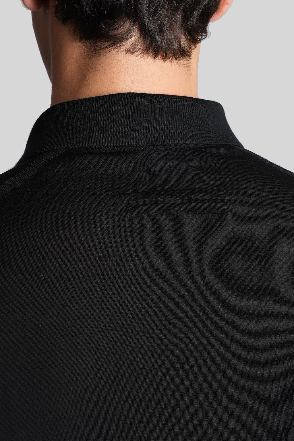 Polo in black wool